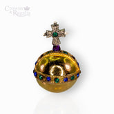 Decorative miniature orb with gemstones on a white background, featuring the brand 'Crowns & Regalia'.